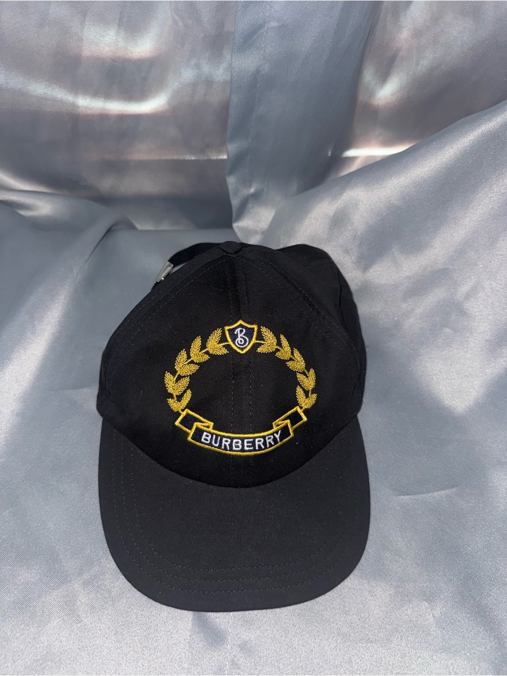 Burberry Black Cap with Gold Laurel Crest